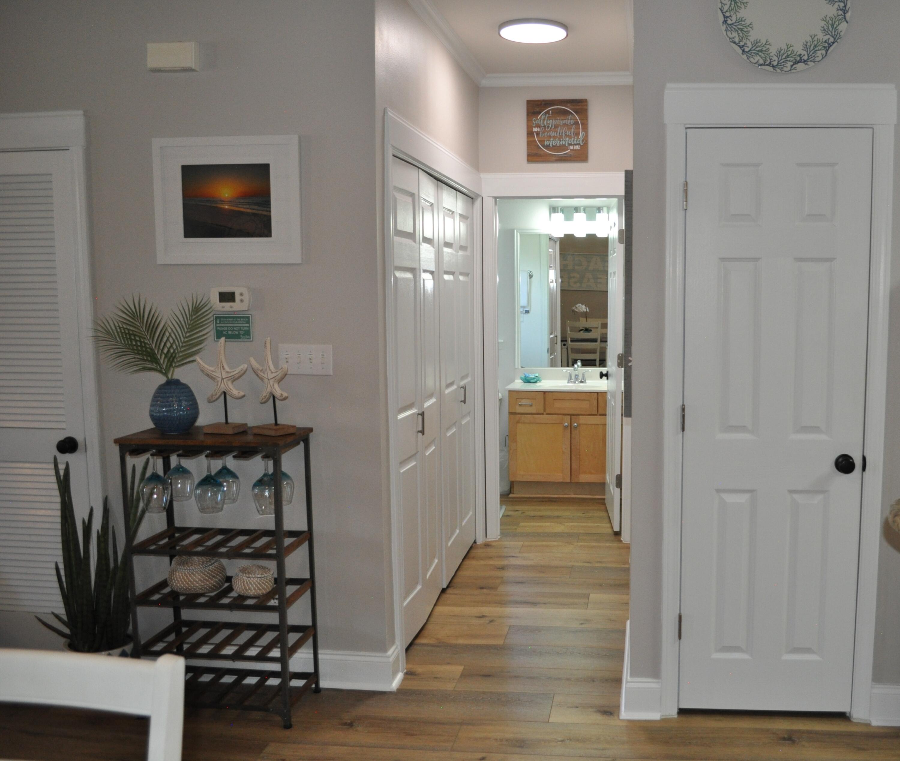 136 Shorebird Drive, Unit 724 Santa Rosa Beach, FL 32459 - Photo 17 of 49 a view of a hallway with wooden floor and a living room