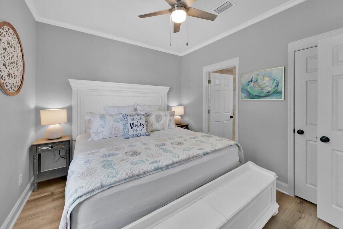 136 Shorebird Drive, Unit 724 Santa Rosa Beach, FL 32459 - Photo 18 of 49 a bedroom with a bed and a chandelier