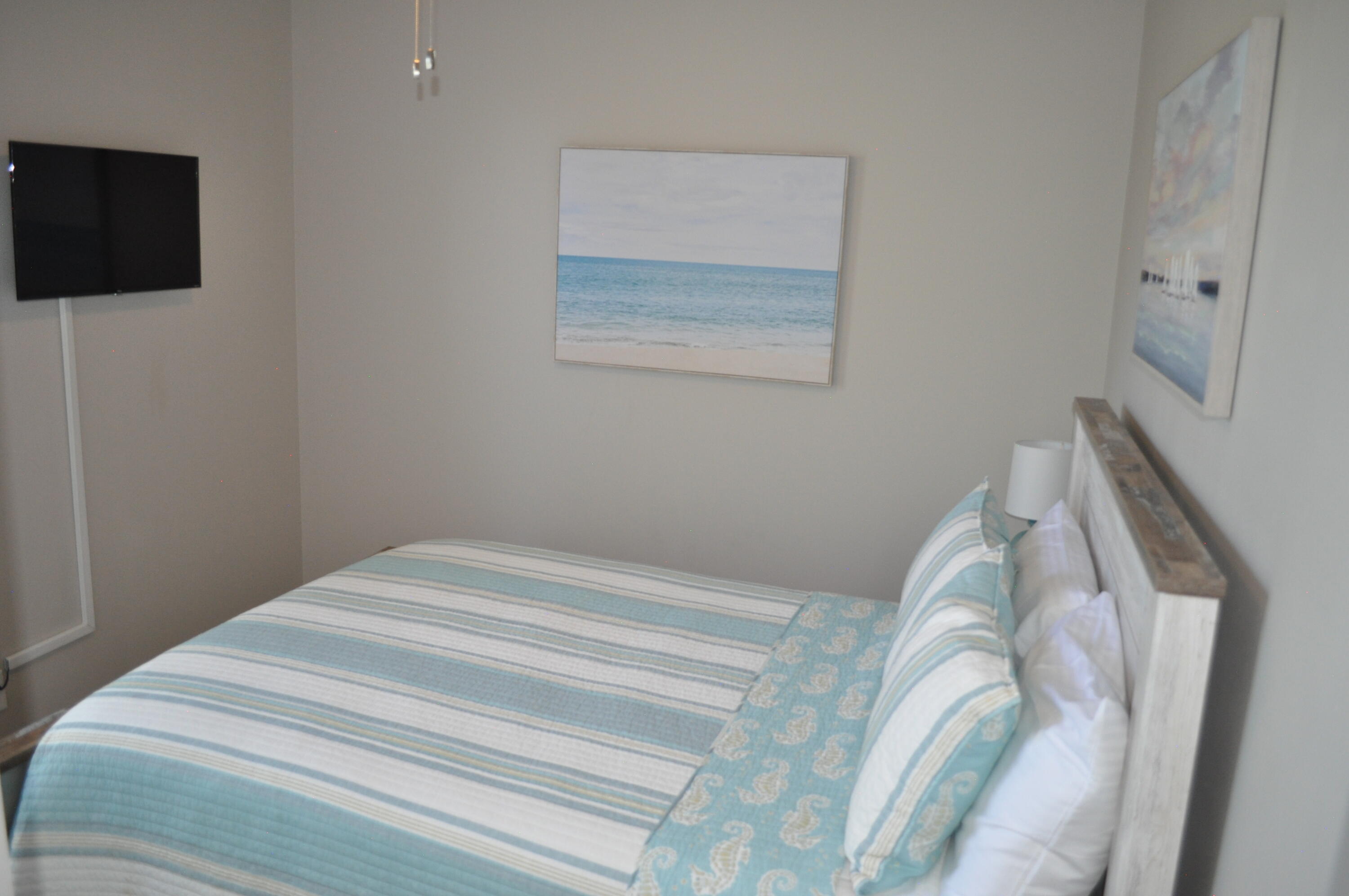 136 Shorebird Drive, Unit 724 Santa Rosa Beach, FL 32459 - Photo 26 of 49 a bedroom with a bed and a flat screen tv