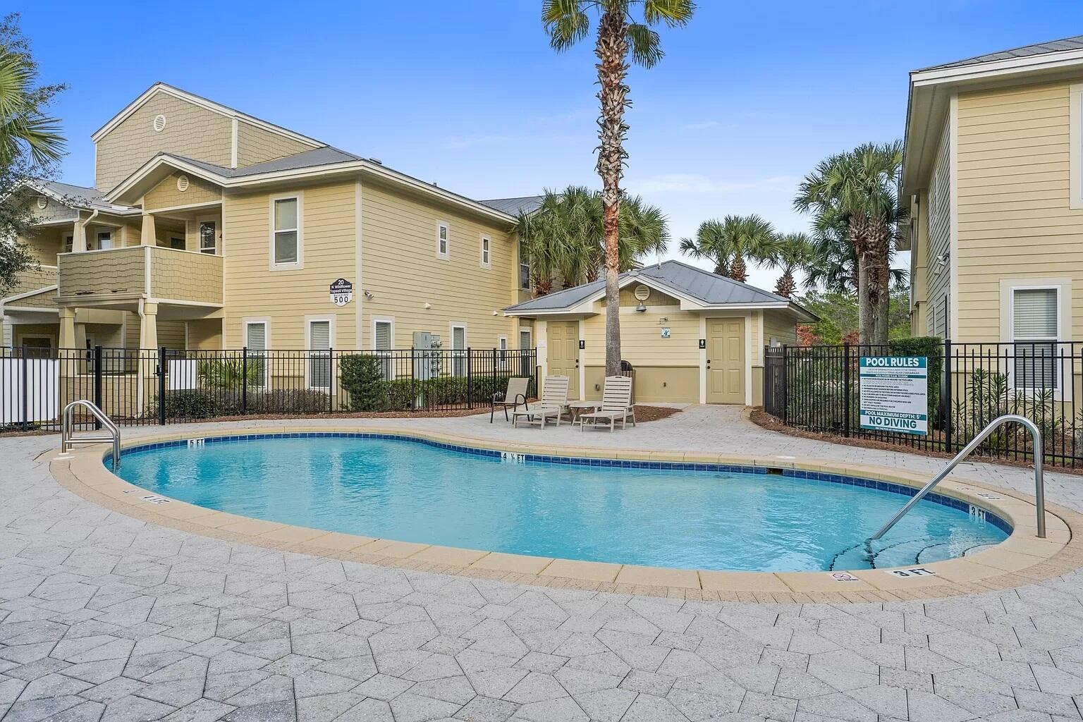 136 Shorebird Drive, Unit 724 Santa Rosa Beach, FL 32459 - Photo 38 of 49 a view of a white house with a swimming pool and sitting area