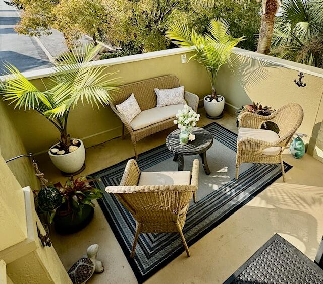 136 Shorebird Drive, Unit 724 Santa Rosa Beach, FL 32459 - Photo 7 of 49 a view of a balcony with chairs and potted plants