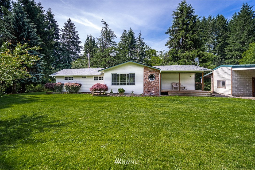 1561 King Road Winlock, WA 98596 - Photo 1 of 23 a front view of a house with garden and trees