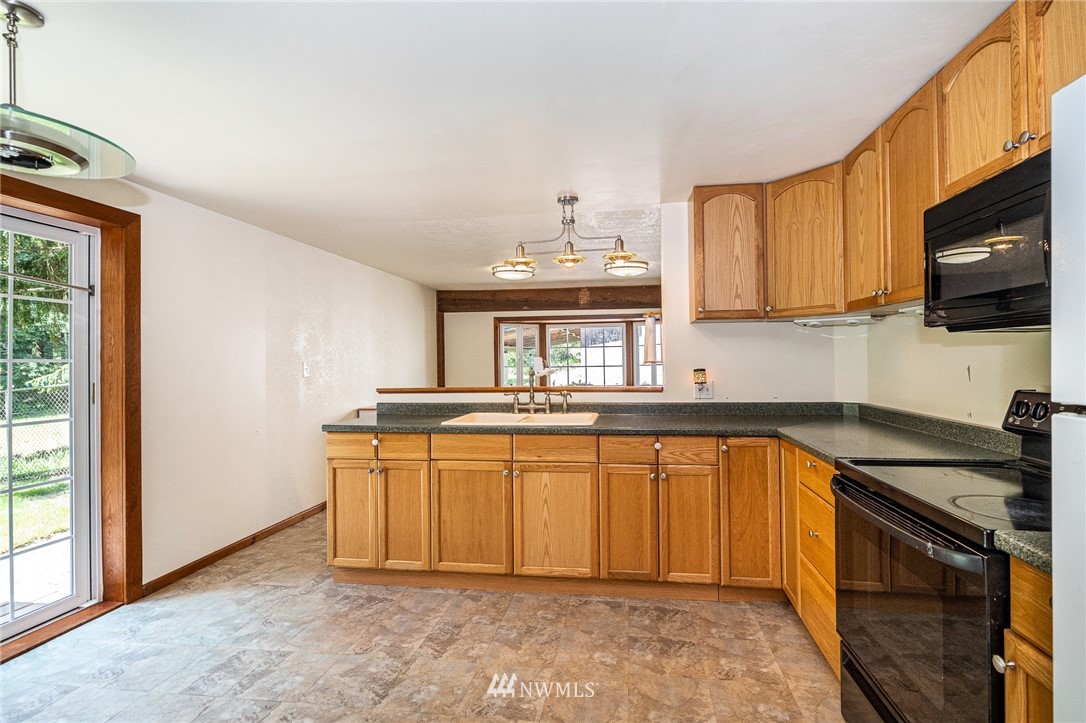 1561 King Road Winlock, WA 98596 - Photo 12 of 23 a kitchen with stainless steel appliances granite countertop a stove a sink and a microwave