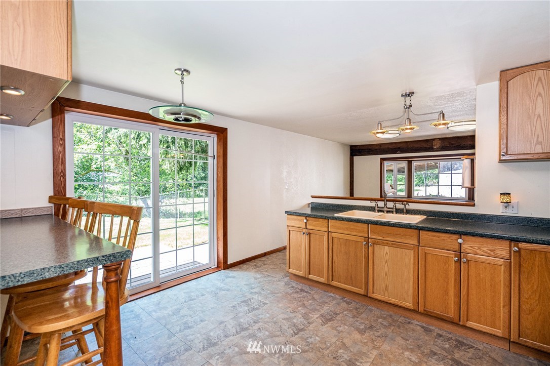 1561 King Road Winlock, WA 98596 - Photo 13 of 23 a kitchen with granite countertop a stove a sink and a wooden floors
