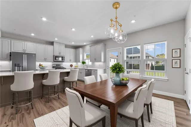 a kitchen with dining table and chairs
