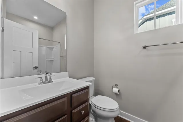 a bathroom with a sink toilet and a mirror