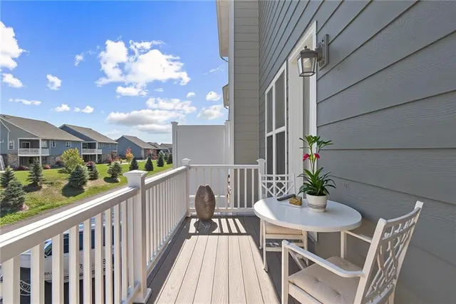 a view of a balcony dining table and chairs