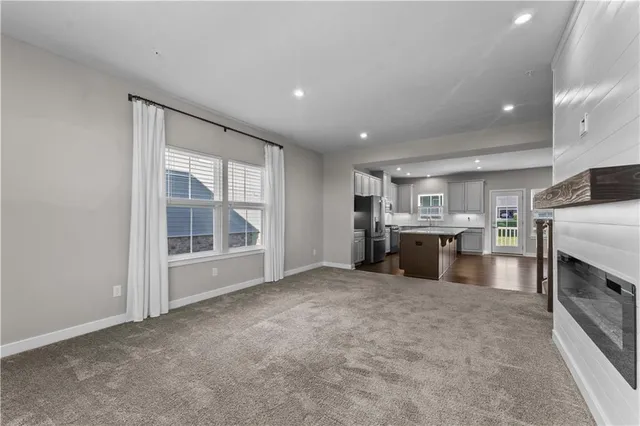 a view of open kitchen with a sink and dishwasher a oven with white cabinets