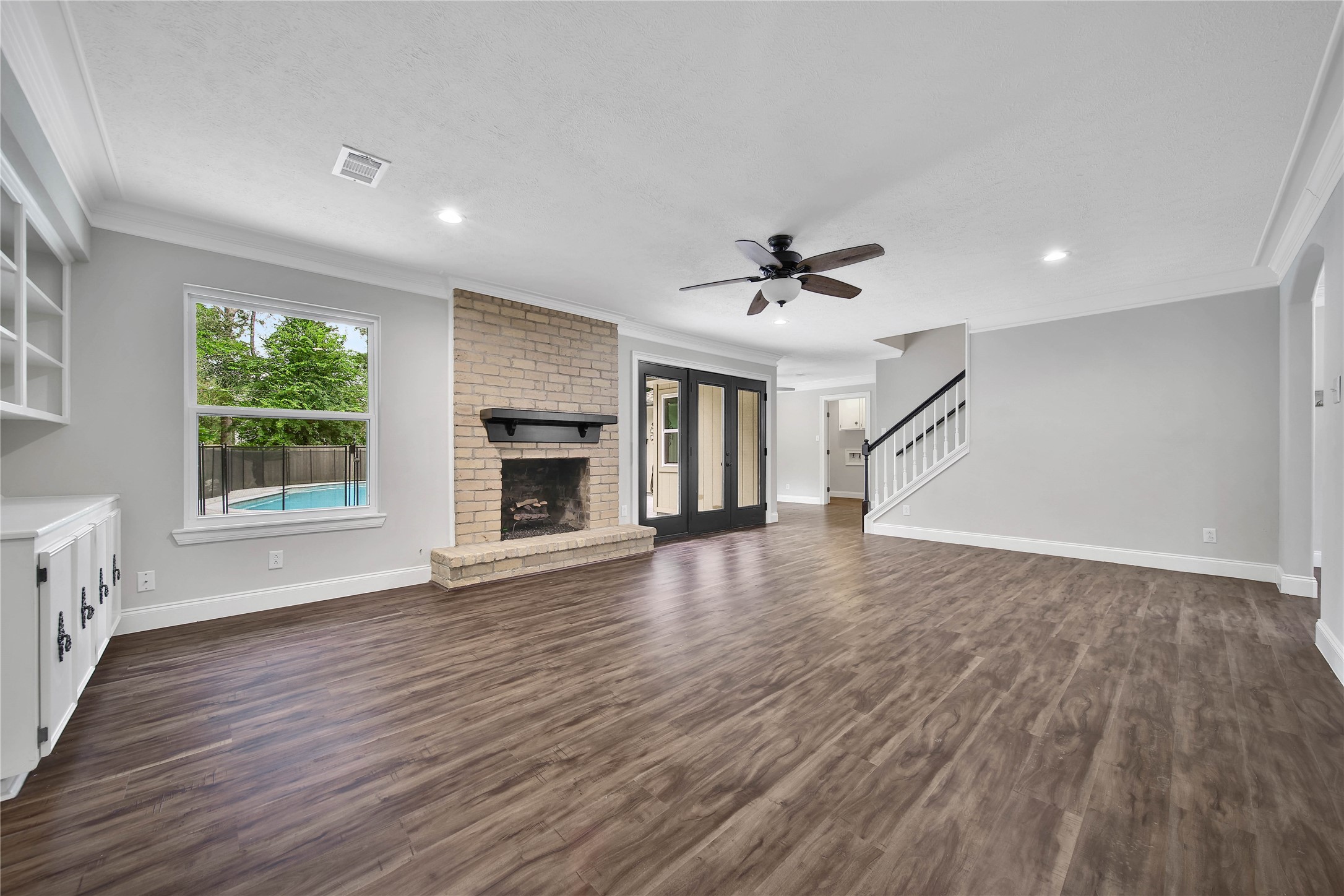 6407 Craigway Road Spring, TX 77389 - Photo 5 of 47 A second view of the family room highlights its easy connection to the kitchen and breakfast area, with the staircase conveniently nearby. The layout creates a comfortable flow between everyday living, dining and entertaining spaces.