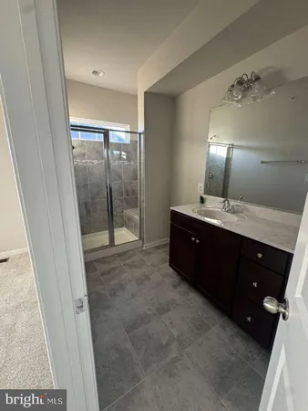 a bathroom with a double vanity sink and a mirror