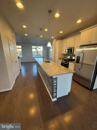 a large kitchen with stainless steel appliances lots of counter space