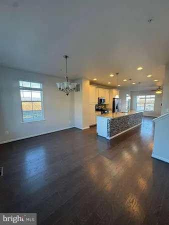 a view of a kitchen with a dishwasher cabinets and a wooden floor