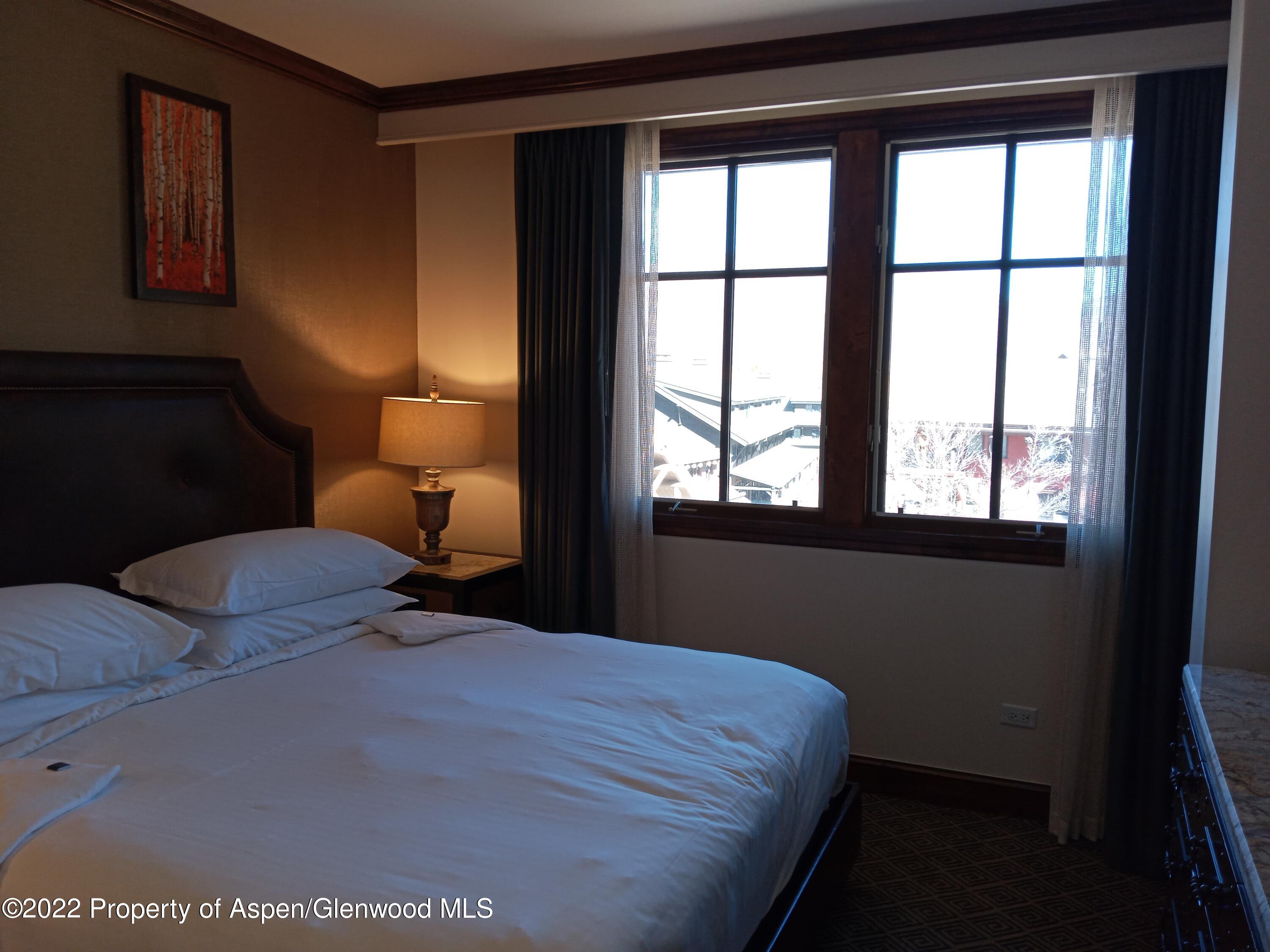 75 Prospector Road, Unit 8408 WINTER INTEREST #6 Aspen, CO 81611 - Photo 14 of 32 a bedroom with a bed and a window