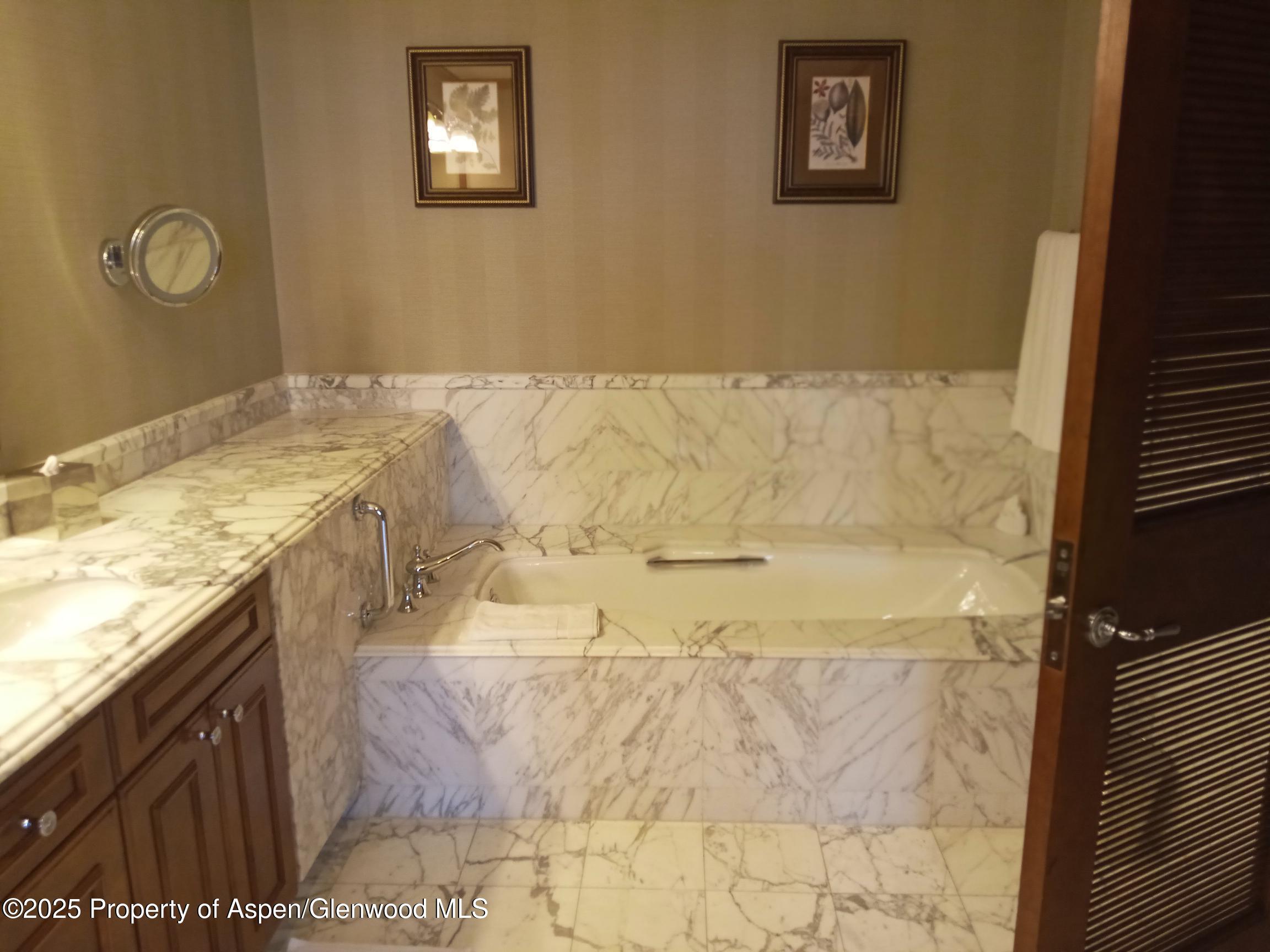 75 Prospector Road, Unit 8408 WINTER INTEREST #6 Aspen, CO 81611 - Photo 25 of 32 a bathroom with a granite countertop sink a mirror and shower