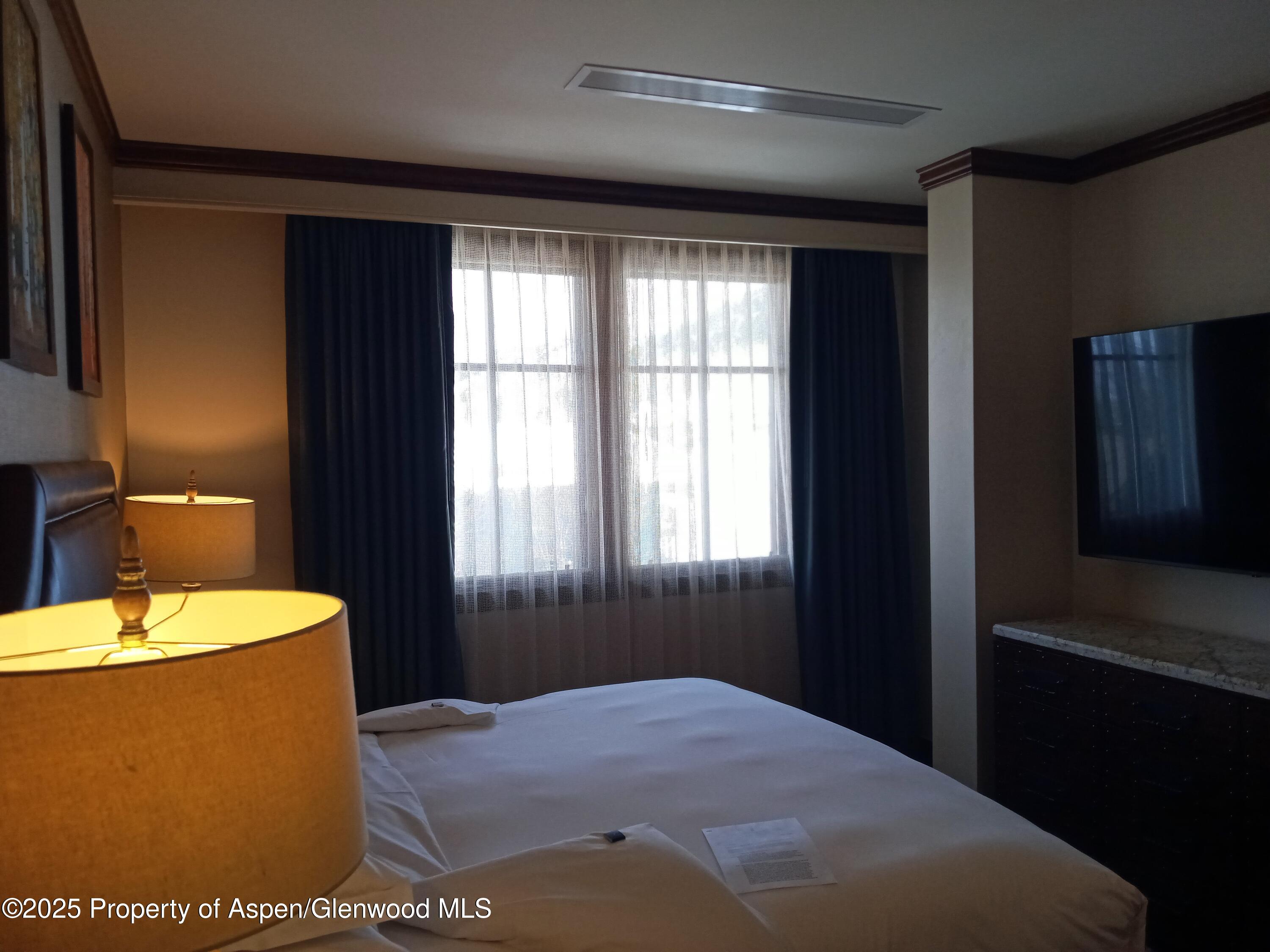 75 Prospector Road, Unit 8408 WINTER INTEREST #6 Aspen, CO 81611 - Photo 32 of 32 a bedroom with a bed and a window