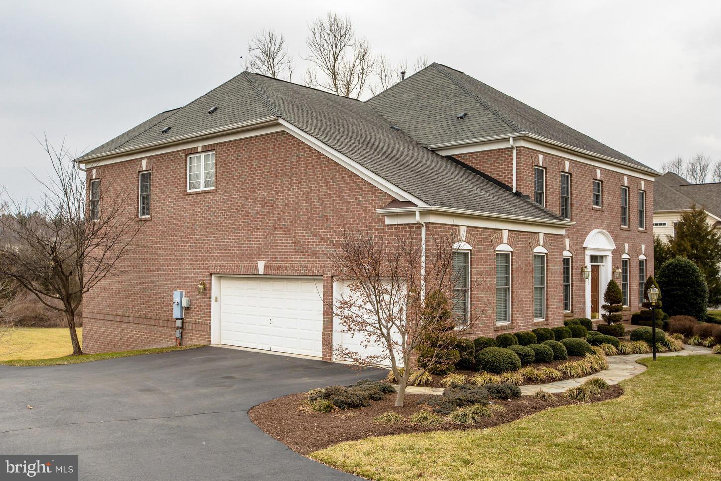 1152 Markell Court Reston, VA 20194 - Photo 2 of 30 a view of a house with a yard and garage