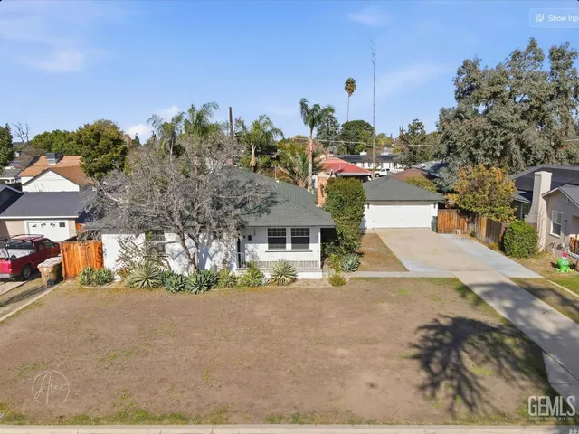 a front view of a house with a yard and a garage