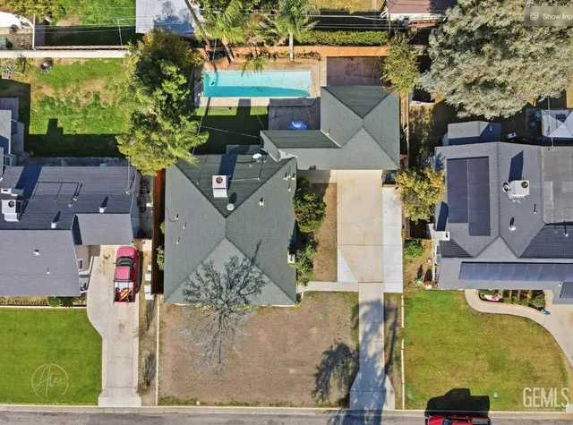 an aerial view of a house with a swimming pool