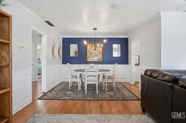 a living room with furniture a window and wooden floor