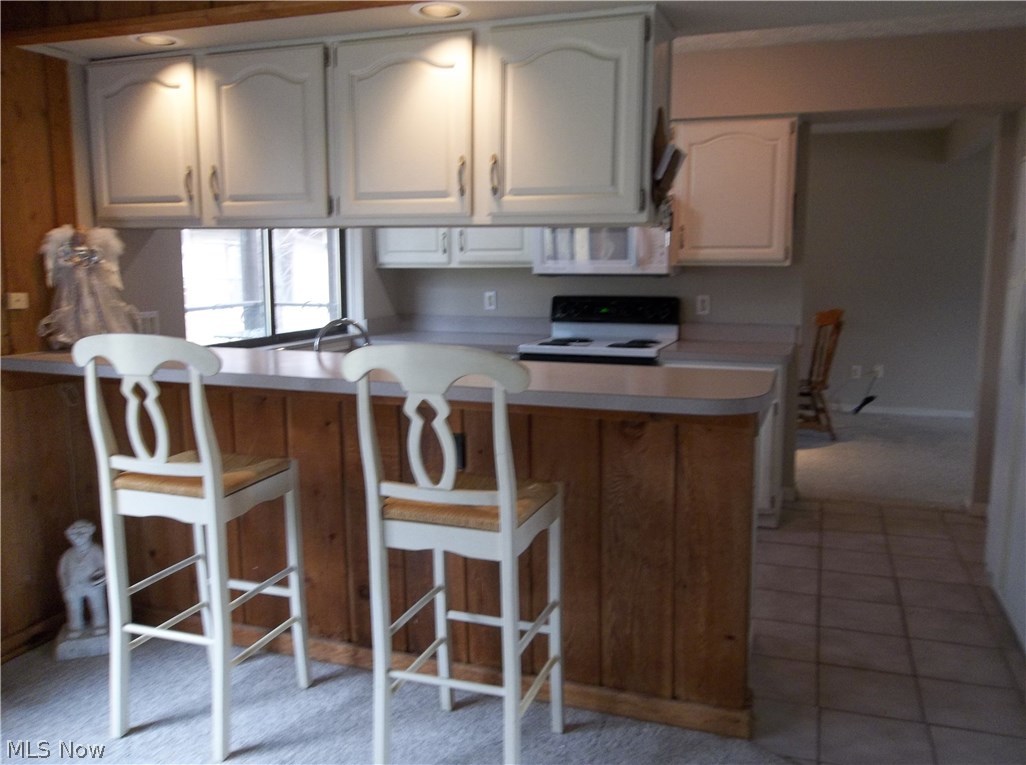 70 Boulder Ridge Place Painesville, OH 44077 - Photo 6 of 26 Relax on the bar stools overlooking the kitchen & enjoy entertaining your guests!