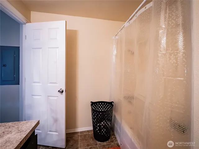 a bathroom with a granite countertop shower curtain