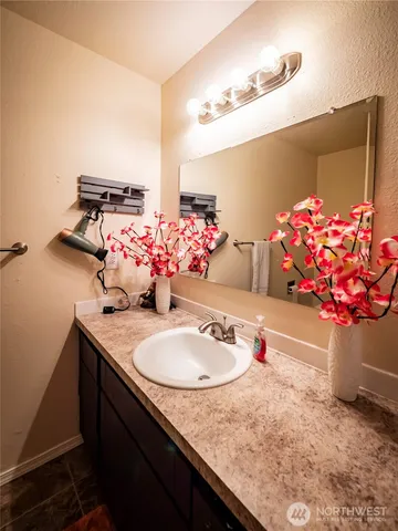 a bathroom with a sink vanity and a mirror