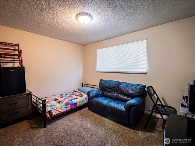 a bedroom with a bed and a couch