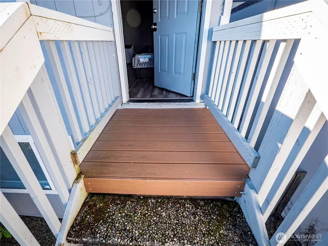 a view of a balcony with chairs and a stove
