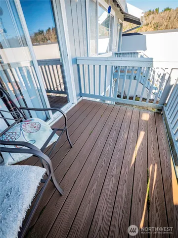a view of backyard with potted plants and wooden fence