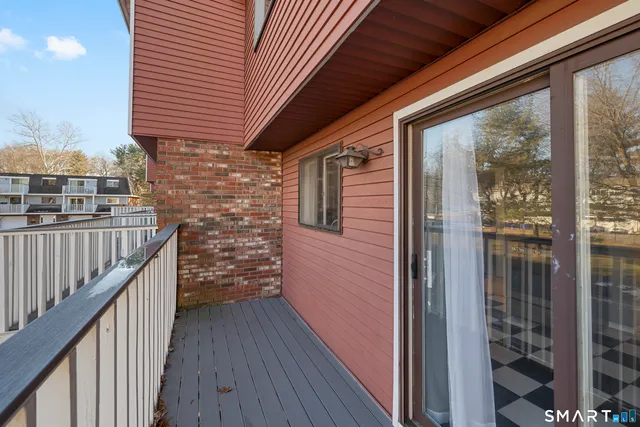 a view of a balcony with wooden floor