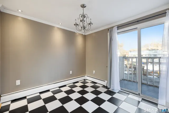 a view of a big room with windows and chandelier