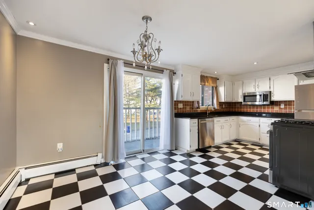 a kitchen with a checkered floor and white cabinets
