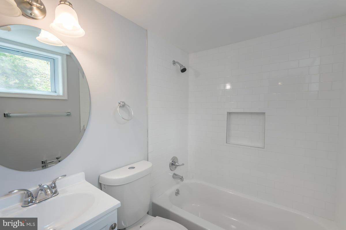 5093 Sheriff Road Northeast Washington, DC 20019 - Photo 14 of 14 a bathroom with a sink a toilet and shower