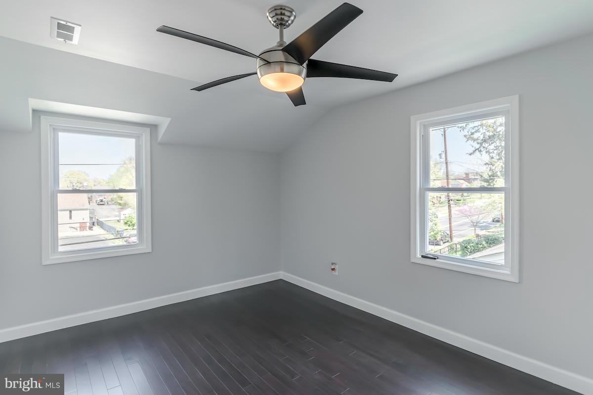 5093 Sheriff Road Northeast Washington, DC 20019 - Photo 8 of 14 a view of an empty room with wooden floor and a window