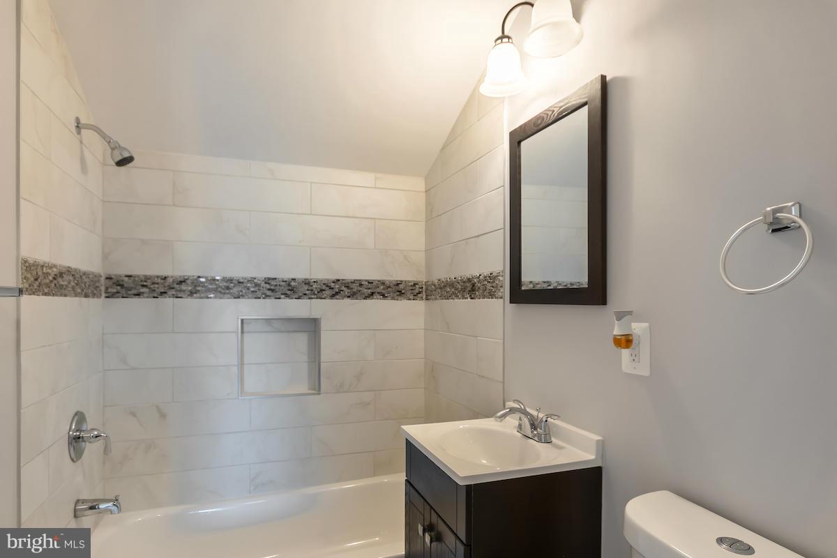 5093 Sheriff Road Northeast Washington, DC 20019 - Photo 10 of 14 a bathroom with a sink a toilet and shower