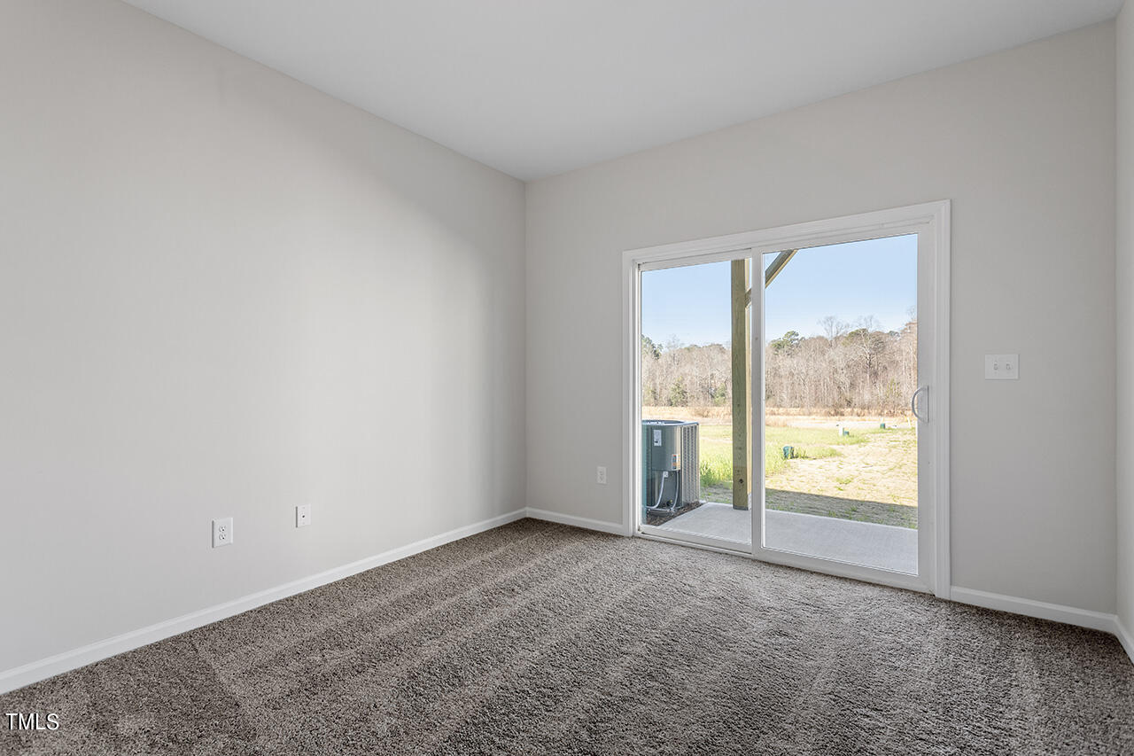 16 Ripple Way, Unit 287 Clayton, NC 27520 - Photo 22 of 24 Main Floor Secondary Bedroom with patio access