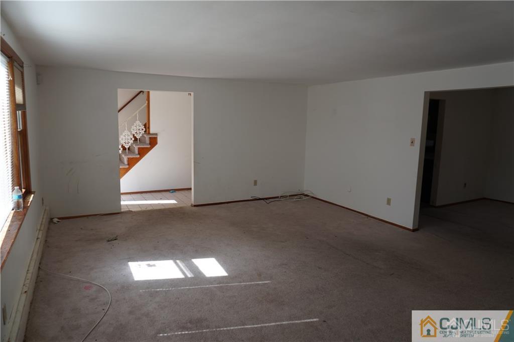 634 Old Stage Road East Brunswick, NJ 08816 - Photo 15 of 17 an empty room with wooden floor and windows