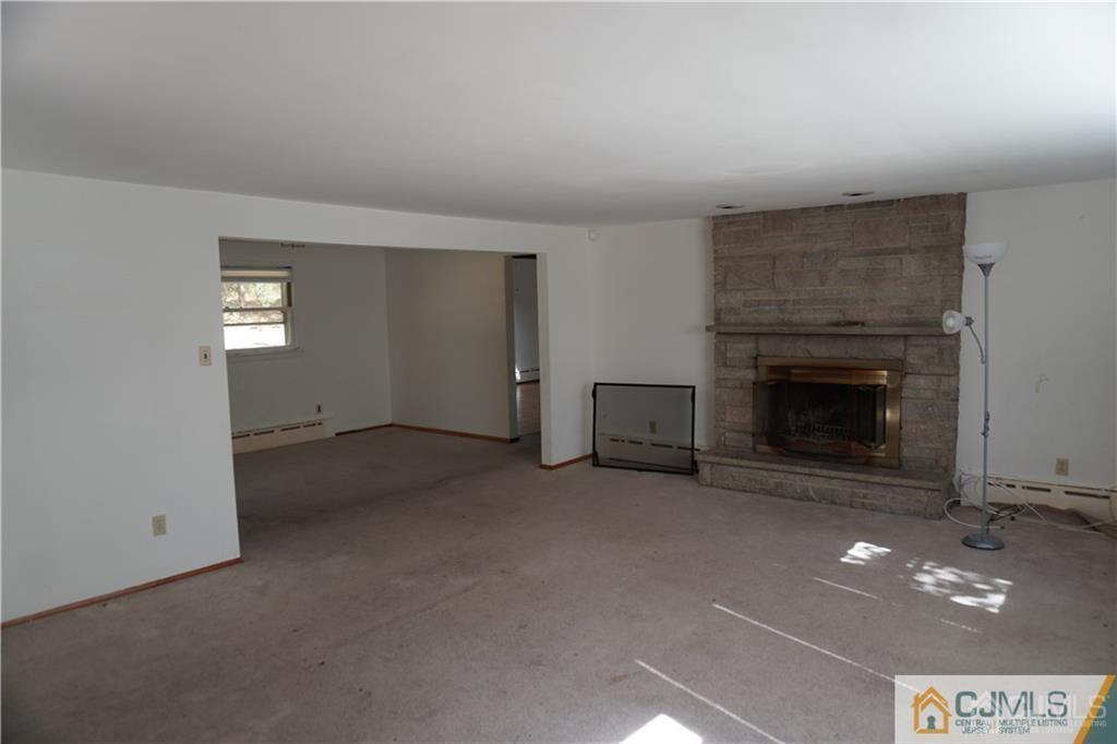 634 Old Stage Road East Brunswick, NJ 08816 - Photo 3 of 17 a view of an empty room with a fireplace