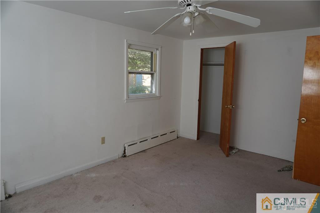 634 Old Stage Road East Brunswick, NJ 08816 - Photo 5 of 17 an empty room with a ceiling fan and a window