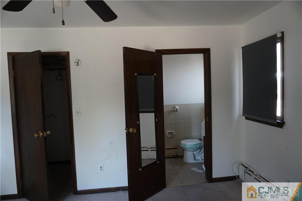 634 Old Stage Road East Brunswick, NJ 08816 - Photo 9 of 17 a bathroom with a toilet and a sink