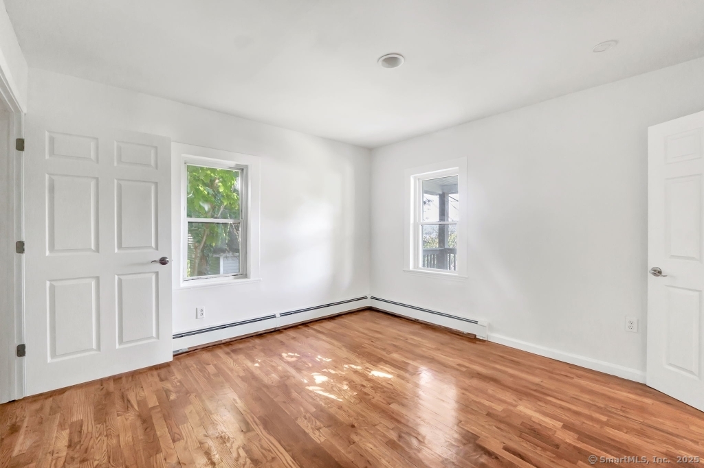 100 Mt Pleasant Street Derby, CT 06418 - Photo 12 of 40 a view of empty room with wooden floor and fan