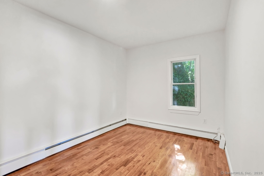 100 Mt Pleasant Street Derby, CT 06418 - Photo 15 of 40 an empty room with wooden floor and windows