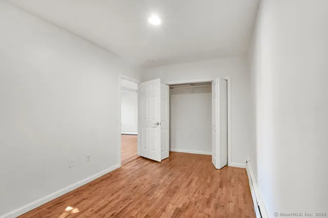 a view of an empty room and wooden floor
