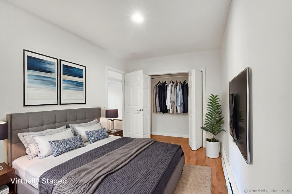 100 Mt Pleasant Street Derby, CT 06418 - Photo 18 of 40 a bedroom with a bed and a large mirror next to a window