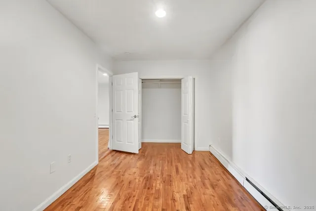 a view of a room with wooden floor