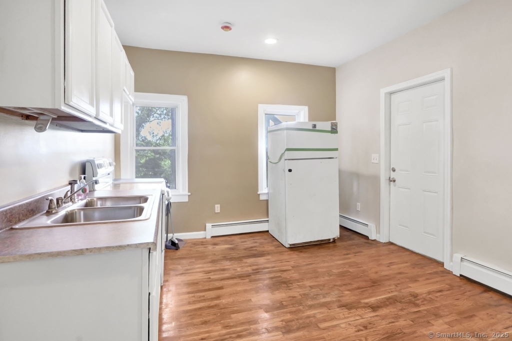 100 Mt Pleasant Street Derby, CT 06418 - Photo 23 of 40 a kitchen with refrigerator and cabinets
