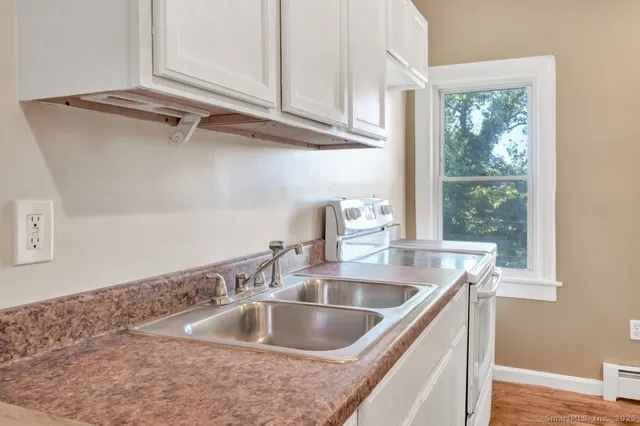 a view white cabinets and a sink