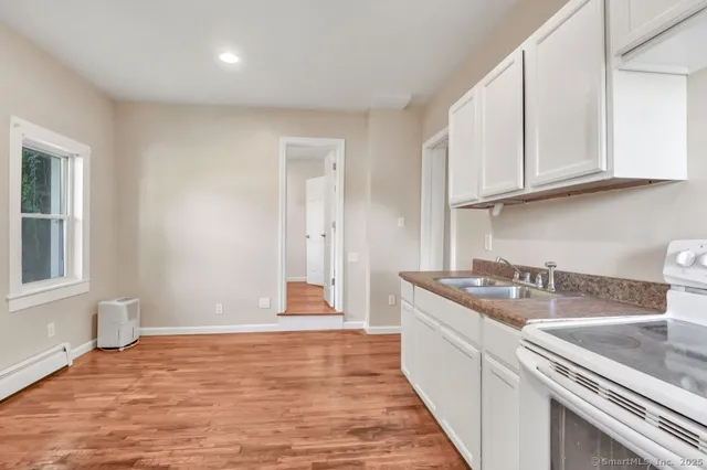 a kitchen with stainless steel appliances granite countertop a sink stove and cabinets