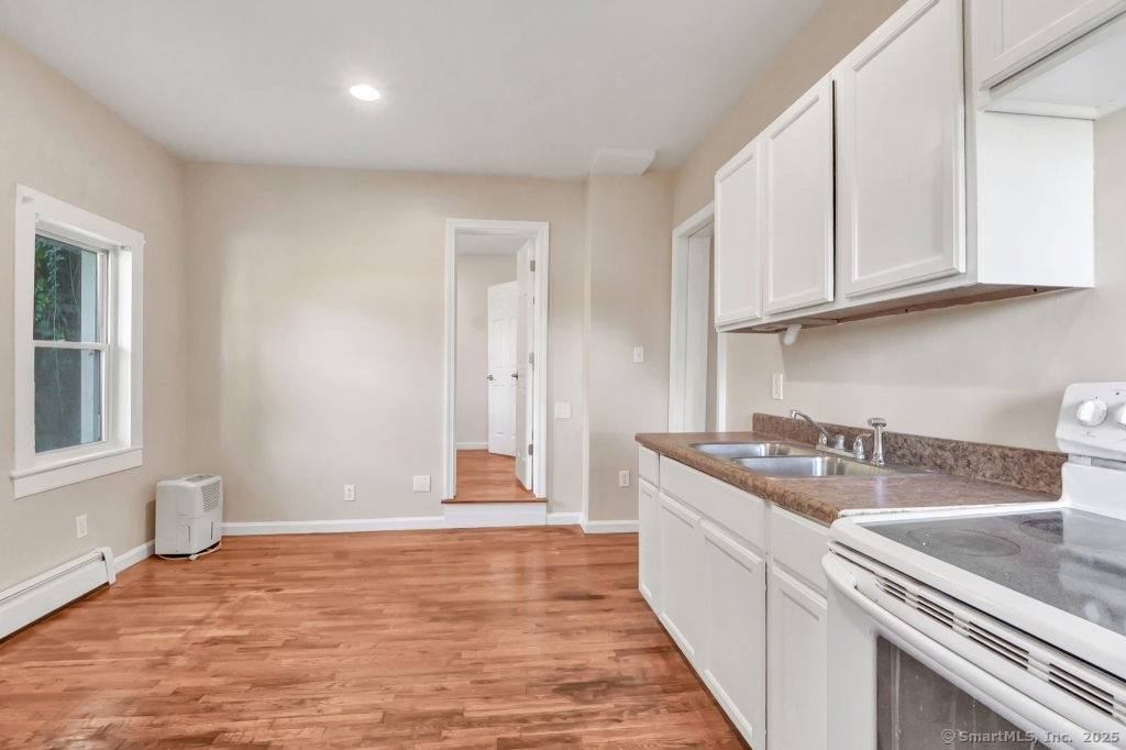 100 Mt Pleasant Street Derby, CT 06418 - Photo 27 of 40 a kitchen with stainless steel appliances granite countertop a sink stove and cabinets
