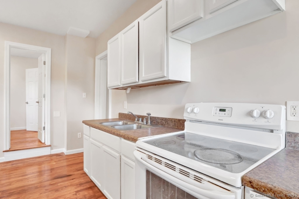 100 Mt Pleasant Street Derby, CT 06418 - Photo 28 of 40 a kitchen with a sink a stove and cabinets